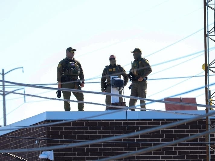 Rooftop guards stand in October 2025 at the Broadview immigration detention center in Illinois, which was accused in a lawsuit of pressuring immigrants to sign voluntary departure papers during detention in squalid conditions.