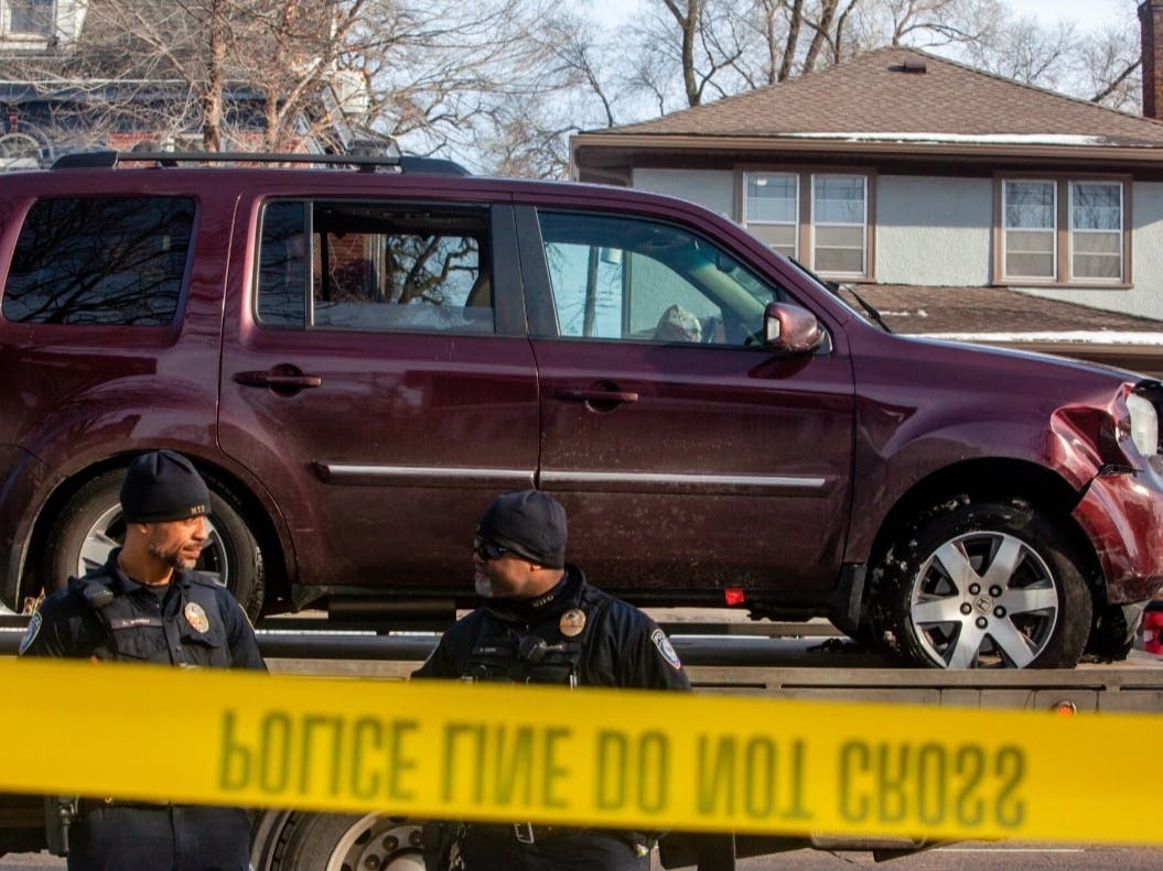  Local police officers stand guard as Renee Good’s car is towed away after ICE officers shot and killed a woman through her car window Wednesday, Jan. 7, 2026, near Portland Avenue and 34th Street. 