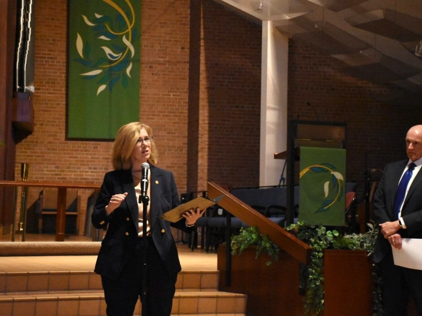 Allina Health CEO Lisa Shannon speaks next to Sutter Health CEO Warner Thomas at a public forum on the proposed acquisition of Allina Health by Sutter Health, hosted by the Minnesota Attorney General’s Office in St. Paul Monday, July 13, 2026.