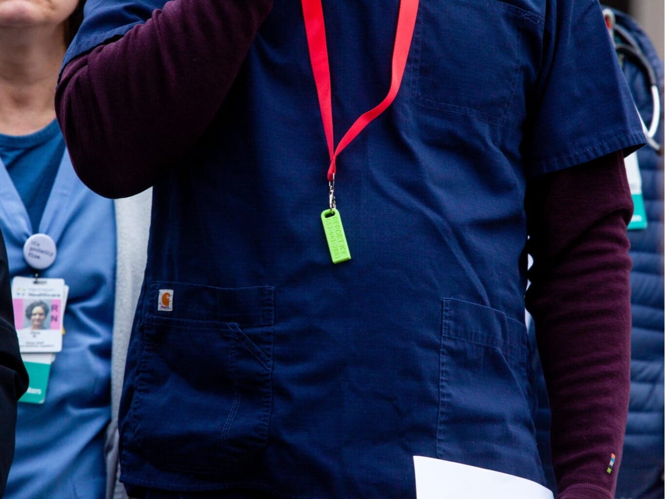 EMT and medical student Jamey Sharp wears a whistle over his scrubs before speaking at a press conference about protocols for ICE encounters at medical centers Tuesday, Jan. 6, 2026 outside of Hennepin County Medical Center.