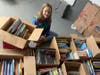Girl Scout Jocelyn O'Neil organizes books.