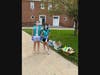 Girl Scouts Maeve Donat and Lily Weaver at a bus stop in Central Greenwich Tuesday, June. 2