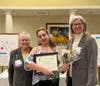 Desiree Delvalle accepts the Ginny Cooper Live Your Dream Award from Jenny Lichtner, SIIR president, and Marlene Piasecki, Past President.