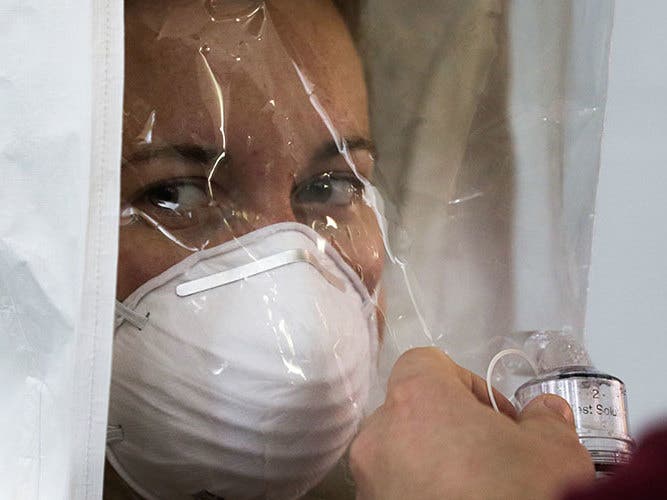 A preventive medicine specialist receives Saccharin spray during contamination suit testing at the Coronavirus Surge Facility in Philadelphia