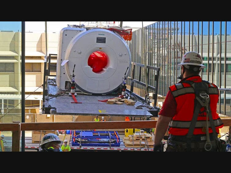 The loading deck carrying the MRI machine approaches the second floor. Landing on the lip of the staging area must be precise to properly anchor the deck.