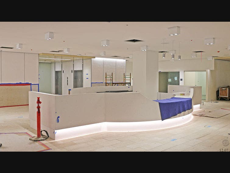 This is the front of the information desk. In the back are four adult elevators. The elevators for the children and their parents are down a hallway to the left of the information desk. To the right is the corridor to the gift shop.
