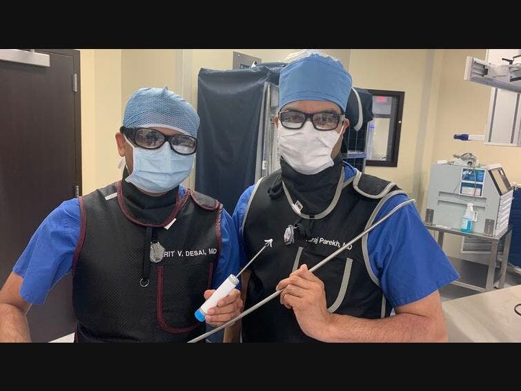 From left, cardiologists Harit Desai, MD, and Niraj Parekh, MD, hold surgical equipment used to repair patients’ heart valves during TMVr — a procedure that saved Elenita Tan’s life in December 2020.