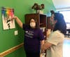 Client Samantha Roldan shows Rep. Amy Grant artwork created by UCP Seguin clients at the recently reopened day center on Carlton Avenue in Wheaton. Clients also learn gardening and cooking skills - among other programs offered at the center. 
