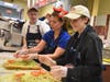 Wish kid Hannah races Senior Wish Manager Jennifer Bennett in a sub making contest with help from Chris Sutton and Rich MacLachlan of Jersey Mike’s Subs during the 2019 Month of Giving