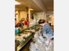 Volunteers prepare meals-to-go at New Covenant Center