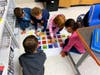 Students spelling using blue bots