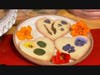 A display of Valentine's heart shortbread cookies with edible flower petals.