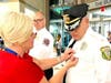 A member of the Voorhees Police Department receives a First Responders’ pin from Sharon Wenner of Samaritan.
