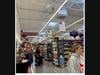 Safeway employee asks a customer if he’d like to sample chewy bar or sample juice . Aisles 1, 2, 3, 4 show where to look for bread, cereal, bakeware,wine.