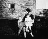 Mary Connor Brady with Maureen and Thomas in front of barns at Springville home about 1939.