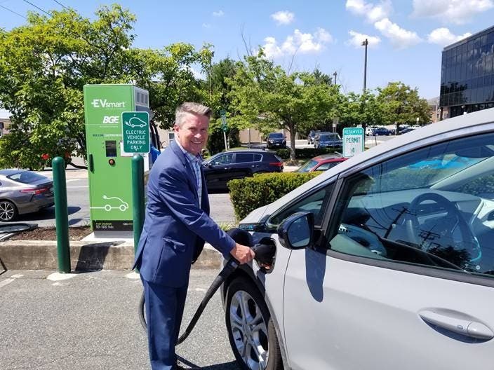 County Executive Barry Glassman uses one of the county's four new electronic car charging stations.