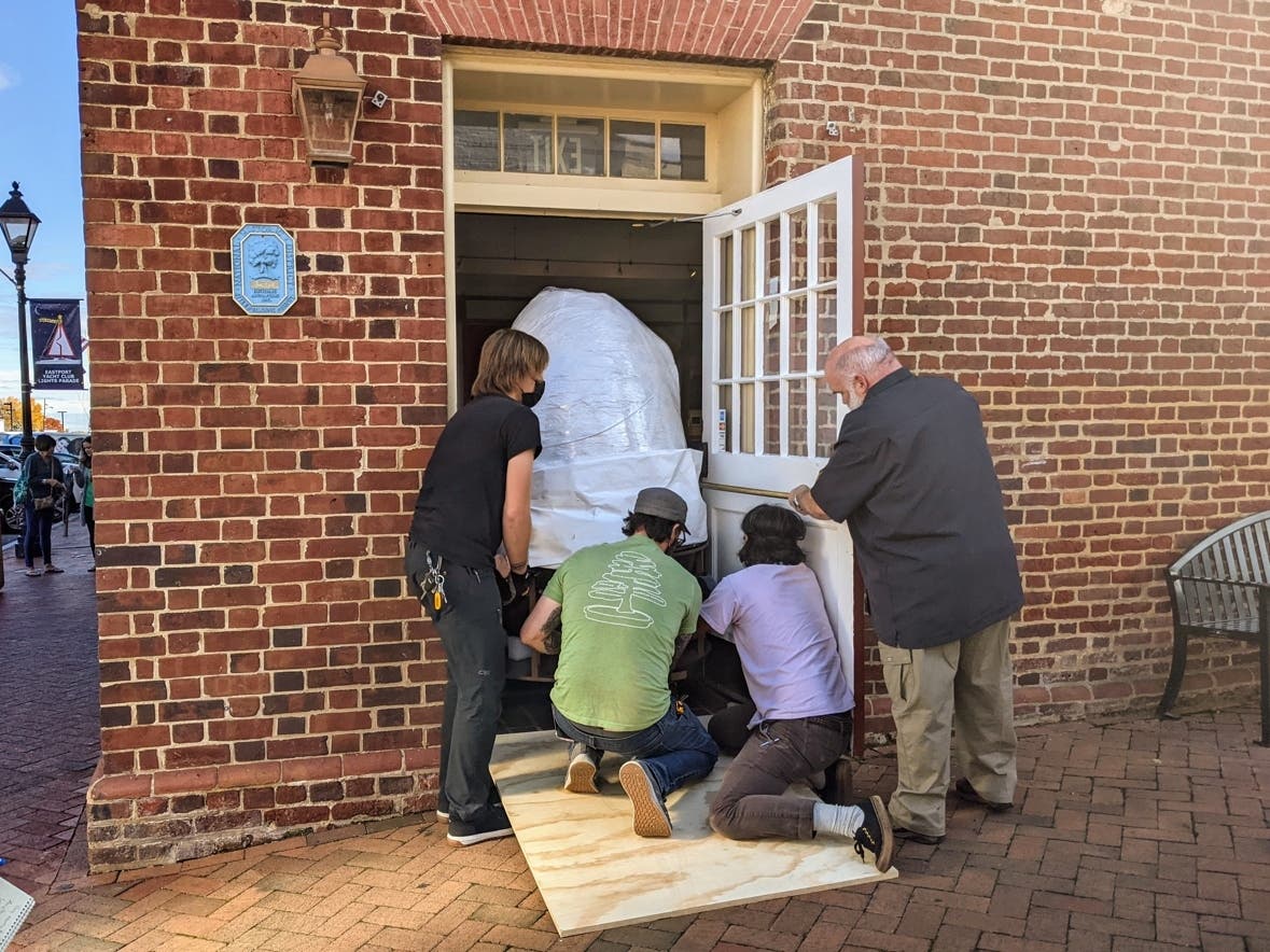 A crew of workers fit the acorn that once sat atop the Maryland State House through the doors of the Historic Annapolis Museum. The acorn will be part of an exhibit chronicling Annapolis' history. 