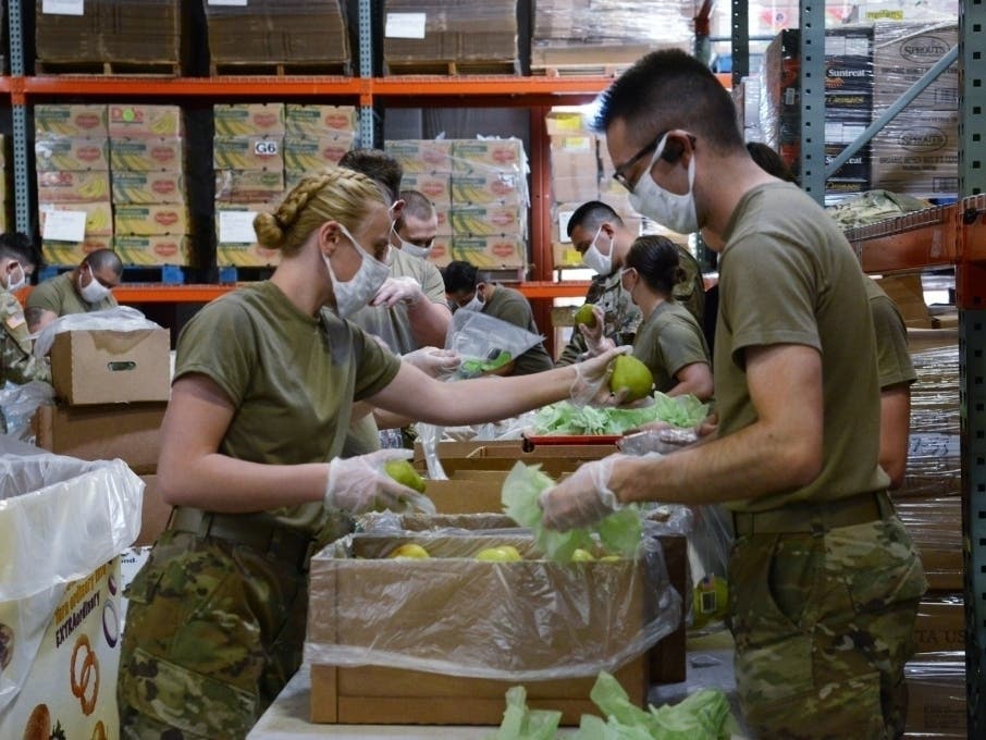 Washington National Guard members help pack food for the Second Harvest Food Bank in Pasco on May 13, 2020. 
