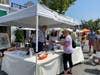 New Canaan Preservation Alliance's booth promoting efforts to save the Town's Landmark 1913 Library draws visitors interested in more information on how to save the iconic building.