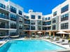 The Mint in Downtown Rahway, NJ boasts a second-floor landscaped deck featuring a pool, BBQ areas, and a firepit. 