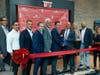 Hackensack Mayor John Labrosse (center right holding scissors) and Hornrock Properties Principal David Hornblass (center left holding scissors) led a ribbon cutting ceremony to formerly welcome Ivy and Green.