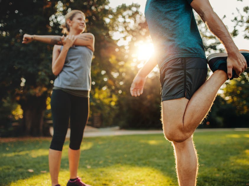 Man and woman working out together outside