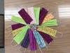 A colorful supply of completed masks