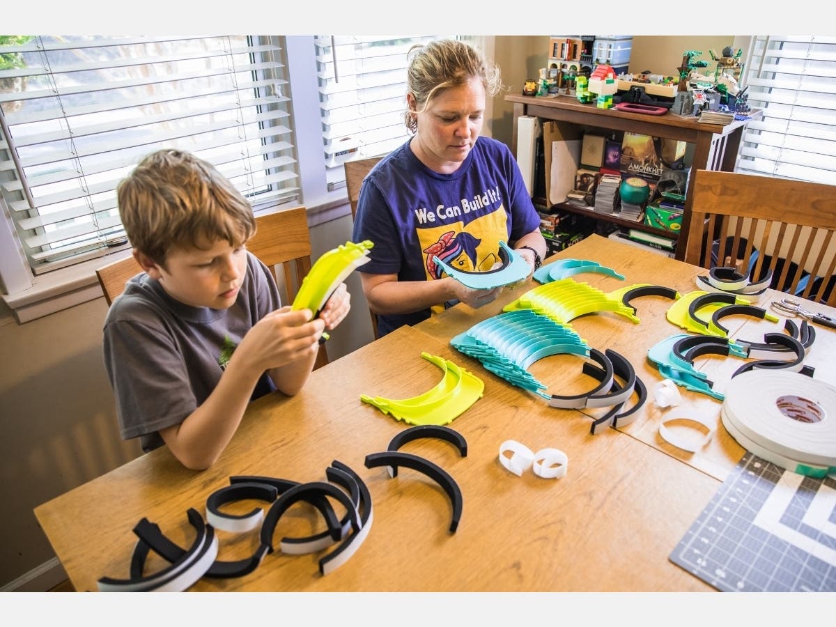 Lisa Kessler, a K-5 innovation space instructor at Viewpoint School, makes Budmen Industries face shields with her son Derek.
