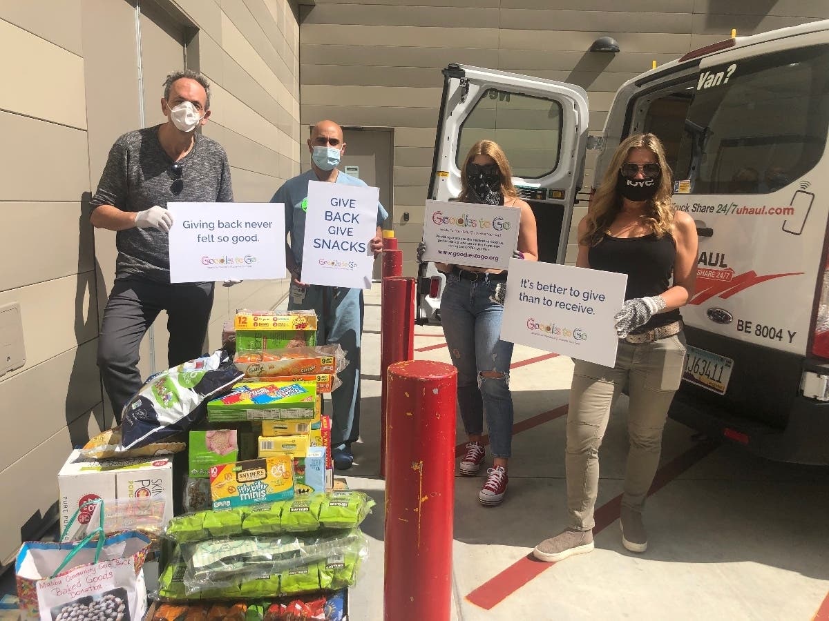 Dave Leib, his former surgeon Dr. Amit Kocchar, and Caren Leib deliver donated snacks to USC Keck