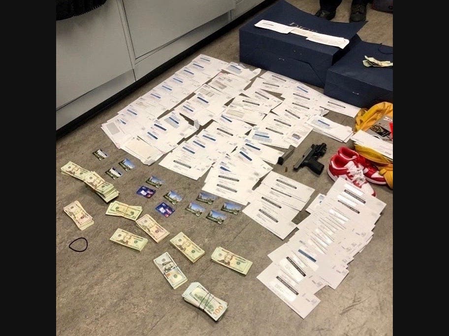 Evidence collected by the Beverly Hills Police Department, which includes handguns, cash, and fraudulent EDD cards. fal
