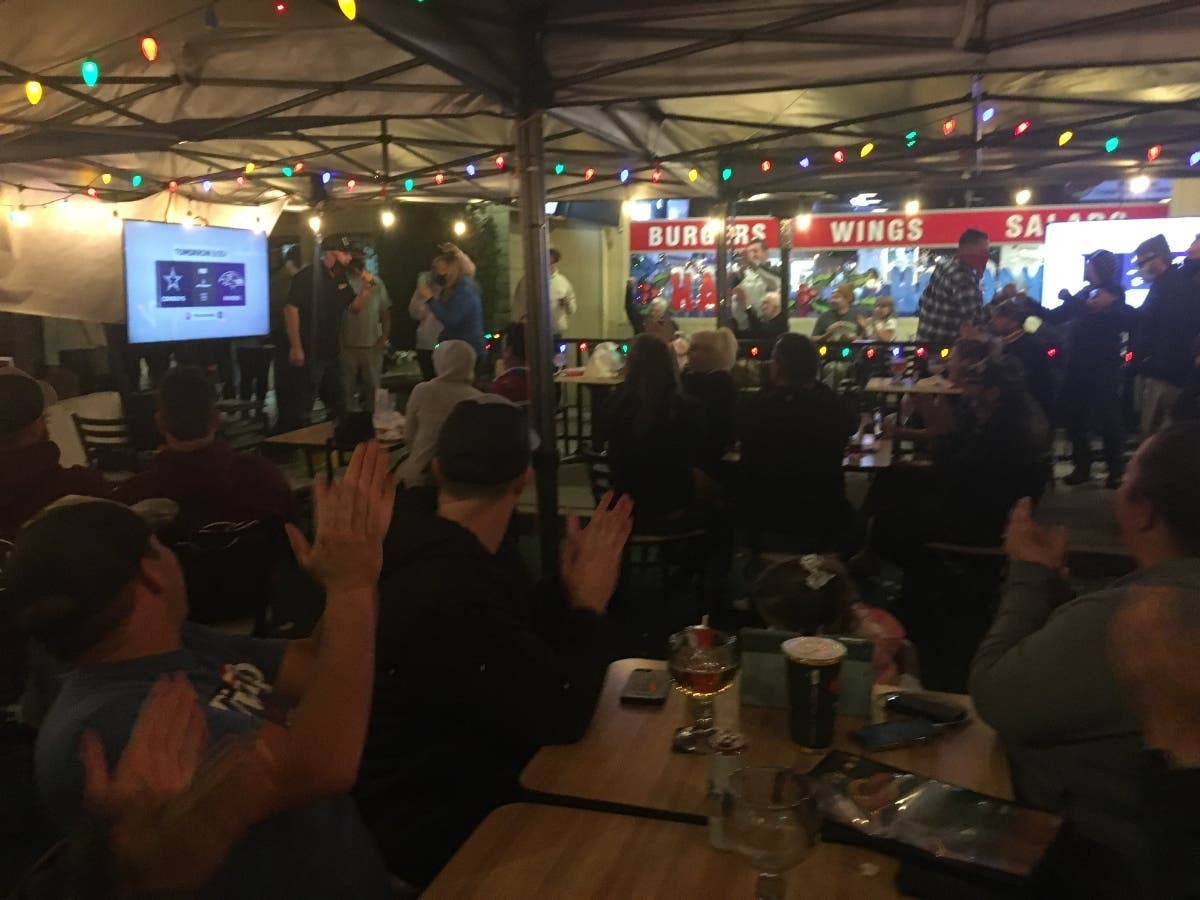 Supporters cheer Cronies owner Dave Foldes in Agoura Hills Monday night.