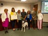 Councilmember Julie Testa, Mayor Karla Brown, Kathy Benn, Fred Benn, Vice Mayor Valerie Arkin, Councilmember Jack Balch, and Valley Humane Executive Director Melanie Sadek all present Gryphon with his award.