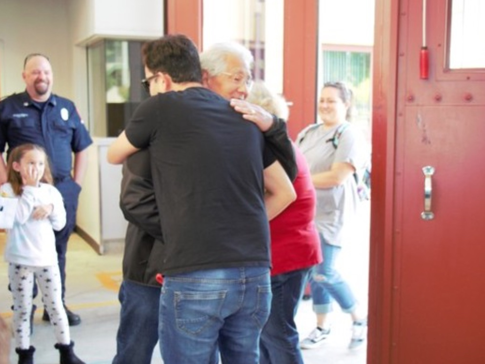 Bilal Shahid hugs Billy Kiyabu, whose life he helped save by performing emergency CPR. 