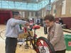 Rotarians, Fallon Middle School students, and Dublin officers worked together to build the bikes and watch the children receive them. 