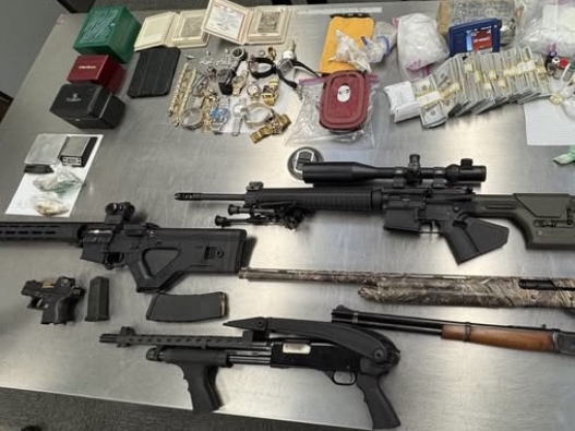 A Dublin man was arrested after police say they found several pounds of drugs, eight firearms, and three luxury cars in his garage.