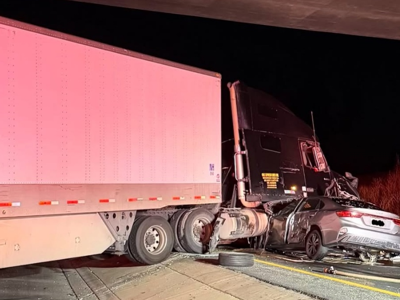 Initial reports indicated that two semi-trucks and six vehicles were involved. One of the semi-trucks jackknifed, and blocked all lanes at one point. At least one vehicle was pinned under the truck, while another vehicle was reported smoking.