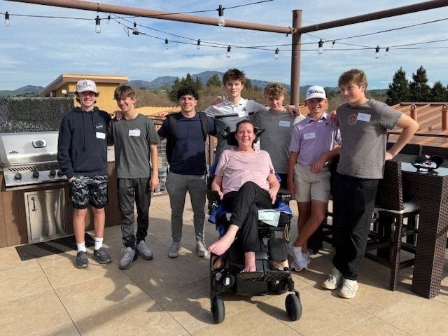 Students meet with Karen, an ALS Network board member living with ALS, as part of Carson Lee's ALS Days of Service. 