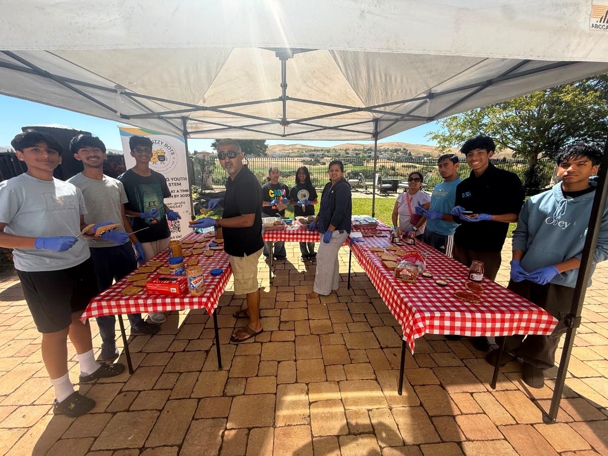 10 local volunteers affiliated with Busy Buzzy Bots helped pack over 100 sandwiches for a local homeless shelter. 