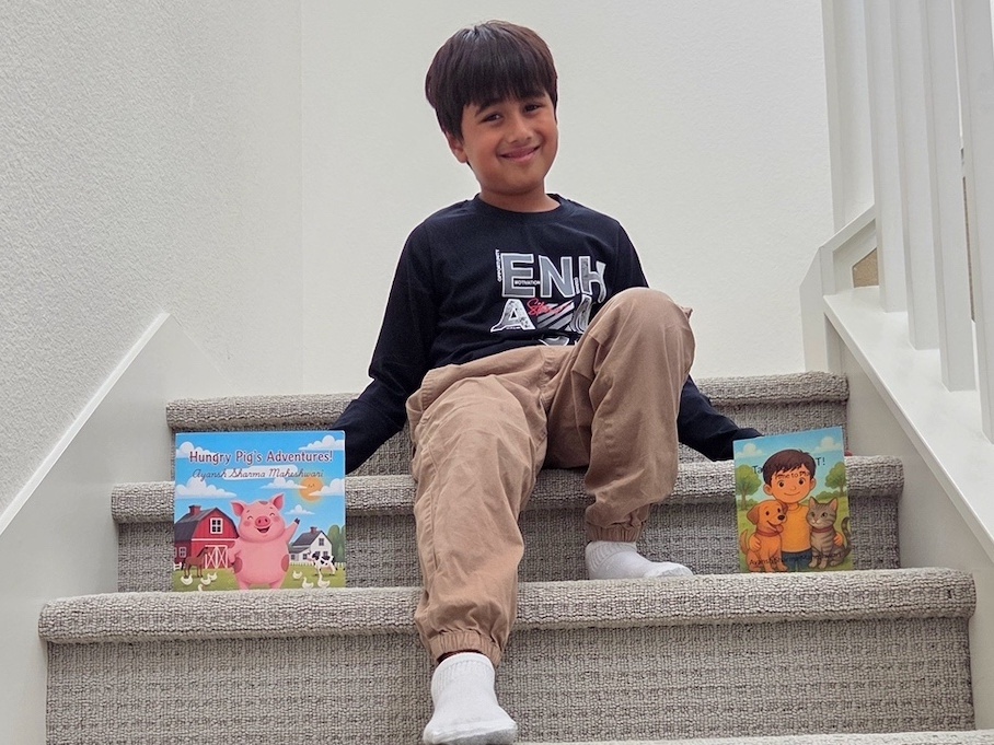 Ayansh Sharma, 6, with the two books he wrote.