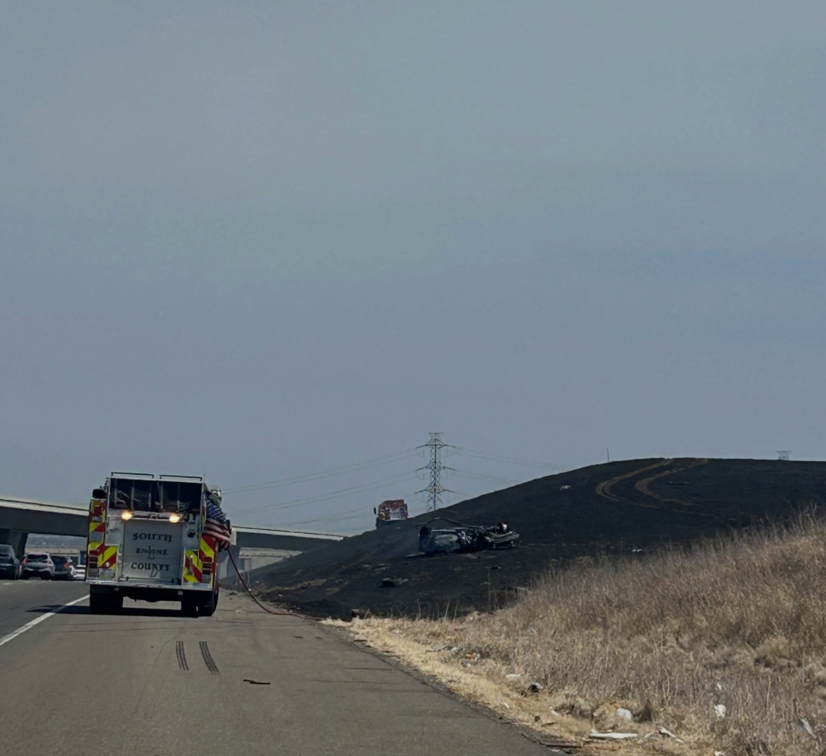 A car fire destroyed the car and spread to neighboring hillside.