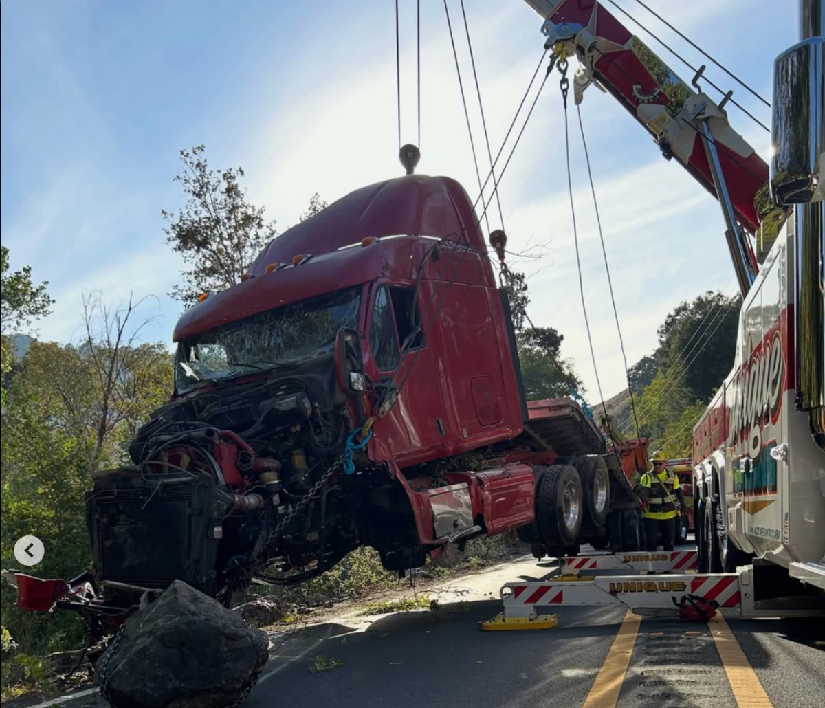 Crews used a heavy-duty crane to hoist the badly damaged cab back onto the roadway.