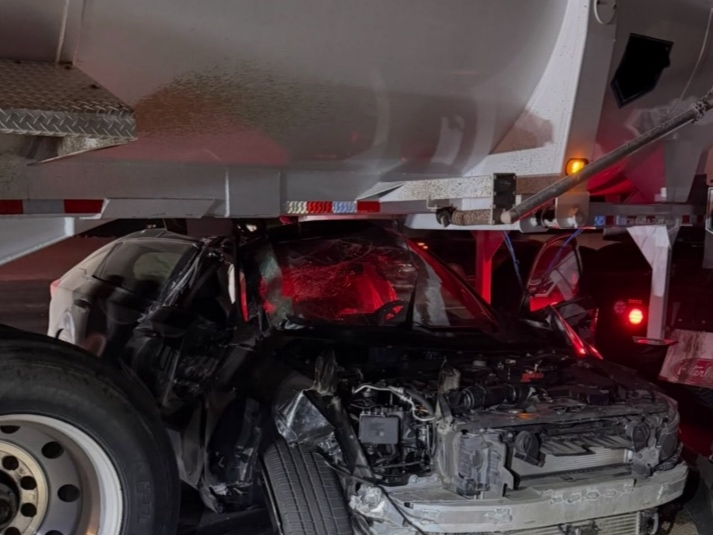 Photos show a badly damaged car completely under the truck, and caused minor damage to the truck. The driver only suffered minor injuries, and the truck driver did not suffer any injuries.