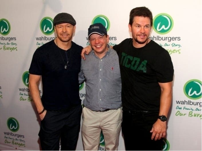 Donnie Wahlberg, Paul Wahlberg and Mark Wahlberg attend the Wahlburgers Coney Island preview party in New York during June 2015. Donnie Wahlberg confirmed last week that the opening of the franchise's St. Charles location has been postponed.