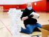 An East Aurora District 131 employee packages some of the 6,000 iPads the district purchased to support remote learning.
