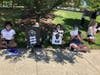 Protesters hold signs in support of the Black Lives Matter movement during a demonstration Monday afternoon in Aurora.