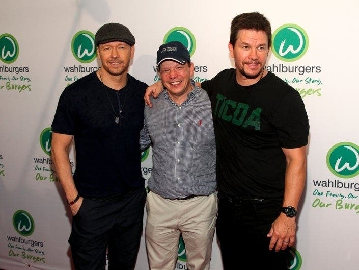 Donnie Wahlberg, Paul Wahlberg and Mark Wahlberg attend the Wahlburgers Coney Island preview party in New York during June 2015. Donnie Wahlberg confirmed last week that the opening of the franchise's St. Charles location has been postponed.
