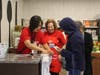 Fanny Na-Chung and Joan Cohen assist in the grocery store.