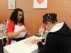 Vernee Stoddard beautifying a client's nails.
