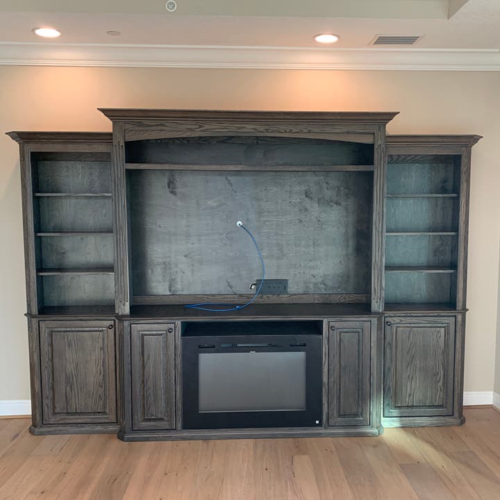 Custom Warm Toffee Entertainment Center with Fireplace Opening