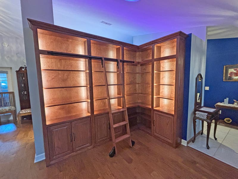 Custom Mahogany Bookcase Library Wall with Sliding Ladder and LED Lighting